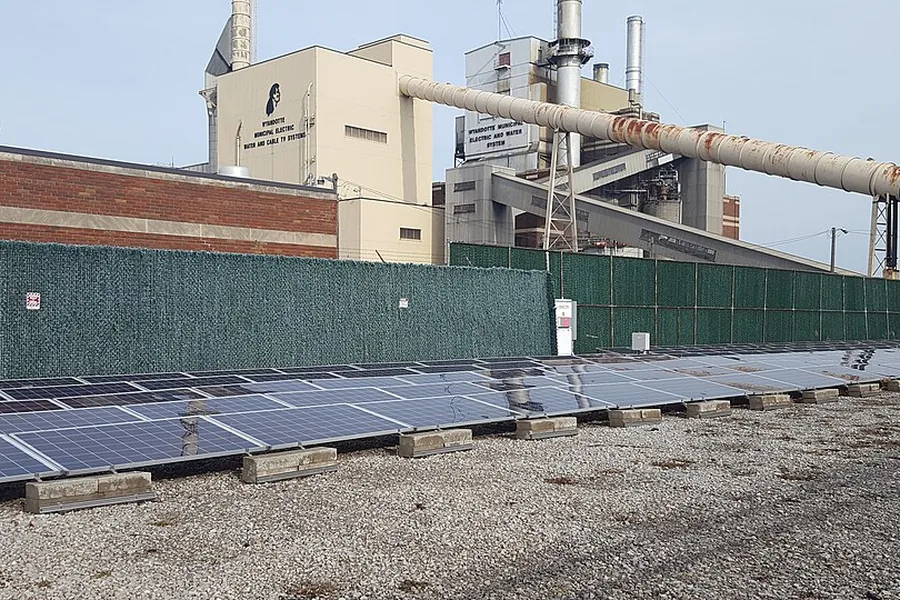Ground-mounted solar array alongside a power plant